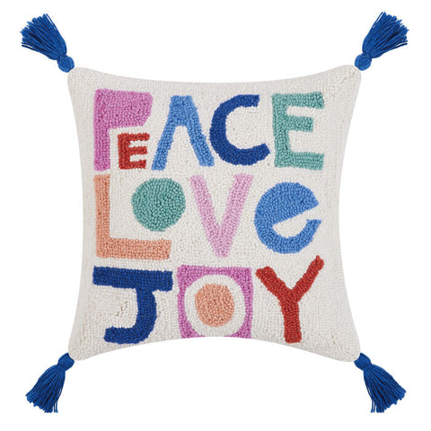 Peace Love Joy square pillow with 4 corner tassels. Multi-colored letters in muted shades of pink, peach, orange, green and blues on a white background. This rectangular shape looks great on a chair, bed, sofa or entry way. www.coast-to-home.com