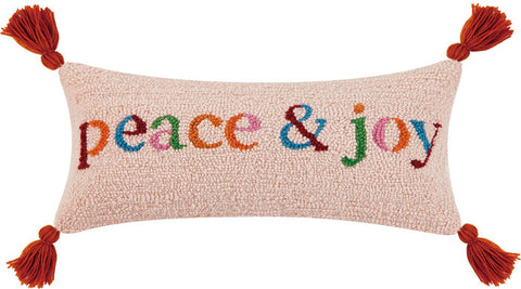 peace & joy lumbar pillow with 4 corner tassels. Multi-colored letters in muted shades of pink, orange, green and blue on a white background. This rectangular shape looks great on a chair, bed, sofa or entry way. www.coast-to-home.com